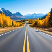 Scenic open road amidst lush green mountains.