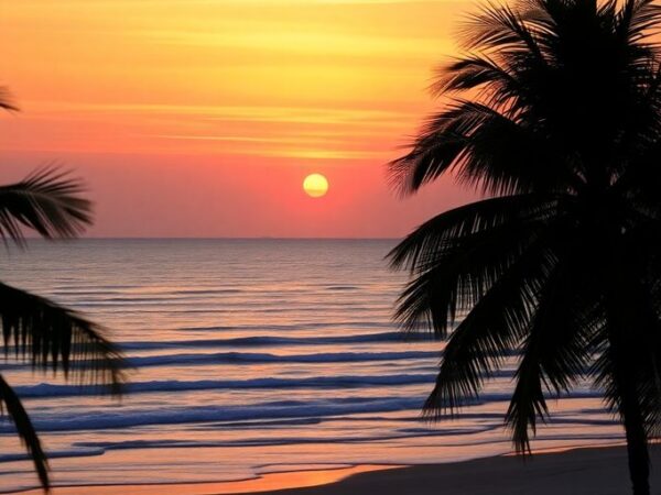 Beach sunset with palm trees and gentle waves.