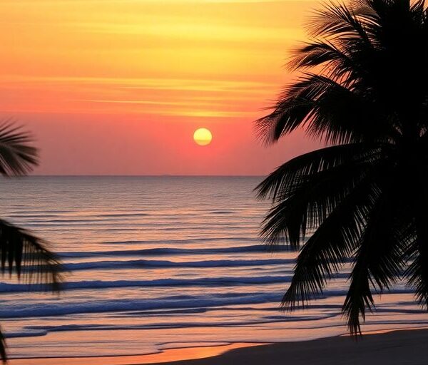 Beach sunset with palm trees and gentle waves.